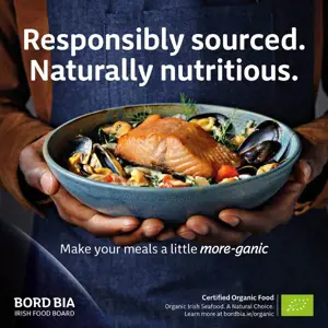 Organic Irish salmon in a bowl being held. Text on image reads "Sustainably sourced, naturally nutritious".