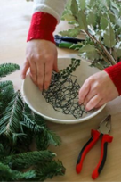hands in bowl holding chicken wire