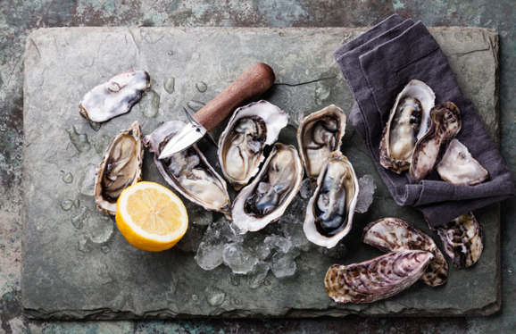 Oysters and lemon slice on slate