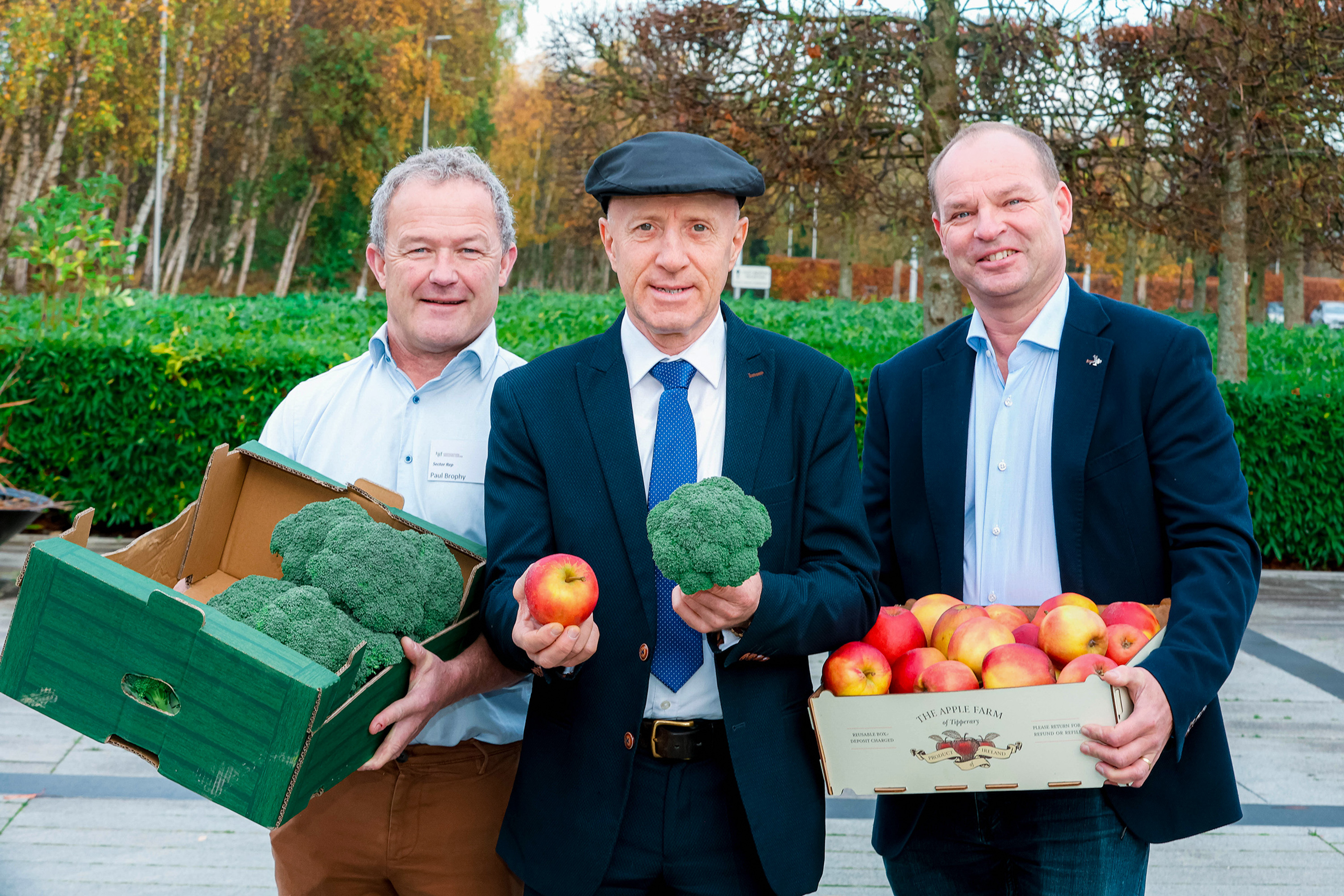 Minister Healy Rae, Paul Brophy and Con Traas holding broccoli and apples